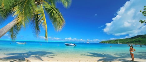 On the beach, white sand, sun loungers, beach towels