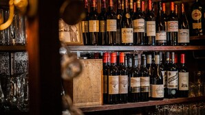 A bar with multiple shelves of wine bottles. - The Brace of Pheasants (Dorchester)