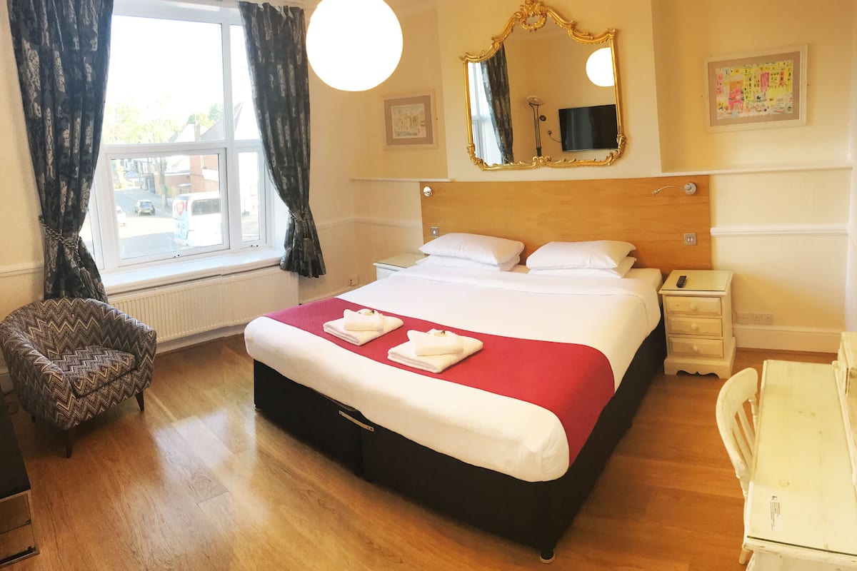Premium bedding, desk, laptop workspace, iron/ironing board