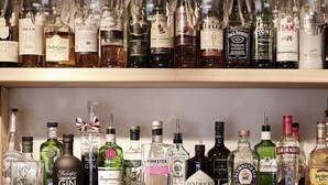 Two shelves of various liquor bottles. - The Masons Arms (Cirencester)