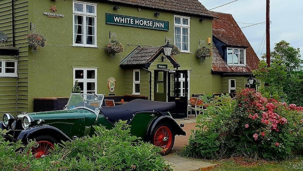 A green building with a sign reading "WHITE HORSE INN". - The White Horse Inn (Cambridge)