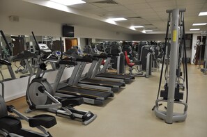 A gym with multiple treadmills, weight machines, and a mirrored wall. - Volley Hotel Istanbul (Istanbul)