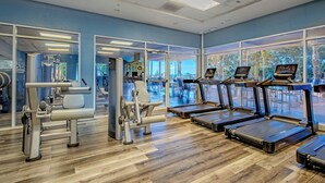 A gym with exercise equipment, treadmills, and large windows. - WorldMark Reunion (Kissimmee)