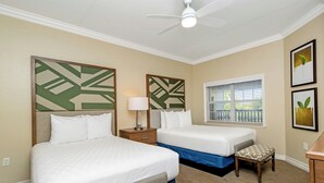 A hotel room with two beds, a ceiling fan, a window with blinds, and artwork on the walls. - WorldMark Reunion (Kissimmee)