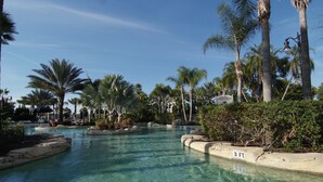 A clear pool surrounded by palm trees and a sign indicating a 3 ft depth. - WorldMark Reunion (Kissimmee)