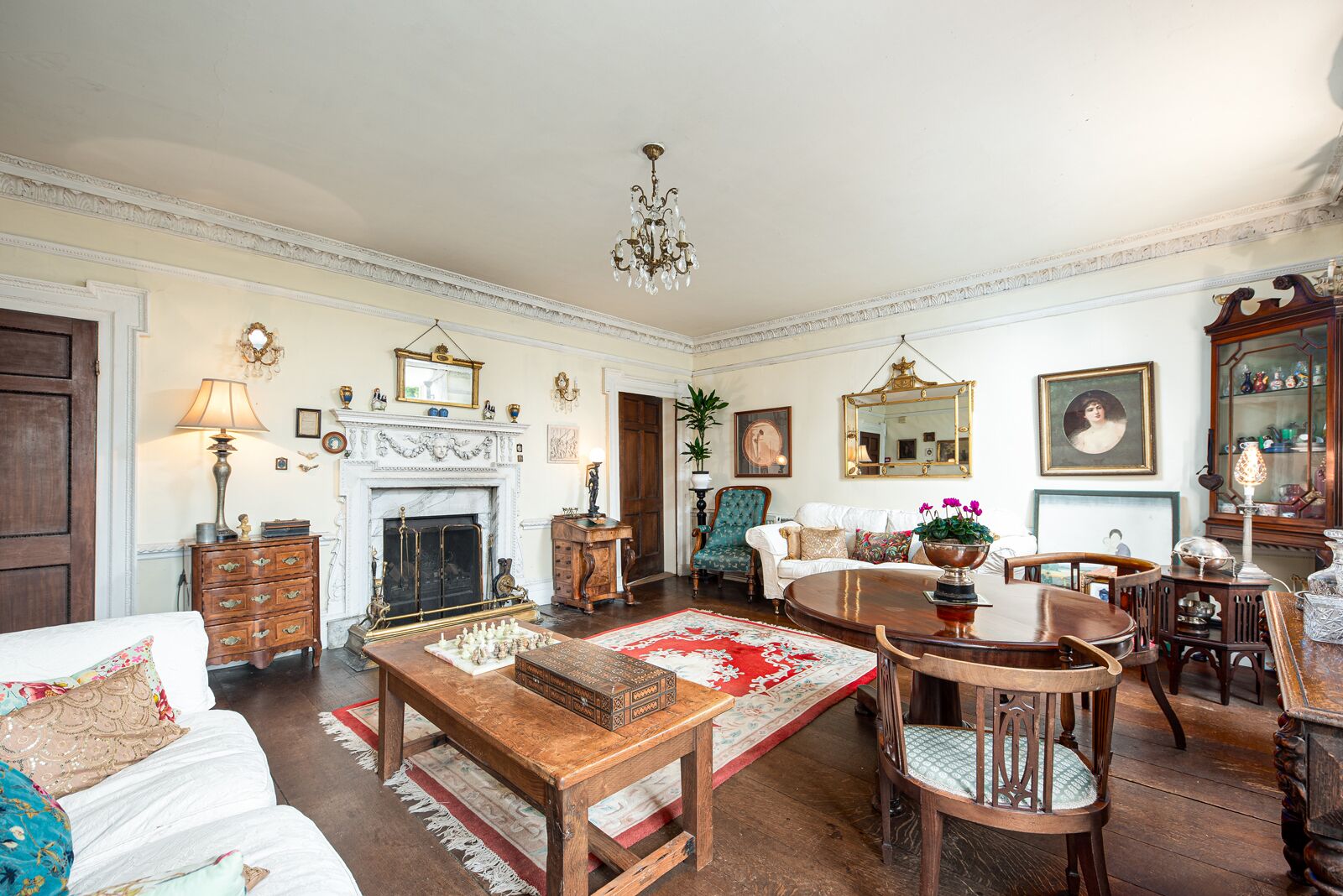 A traditional living room with a fireplace, wooden furniture, and classic decor.