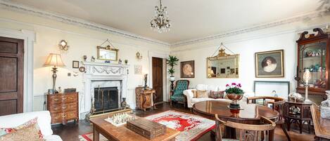 A traditional living room with a fireplace, wooden furniture, and classic decor.