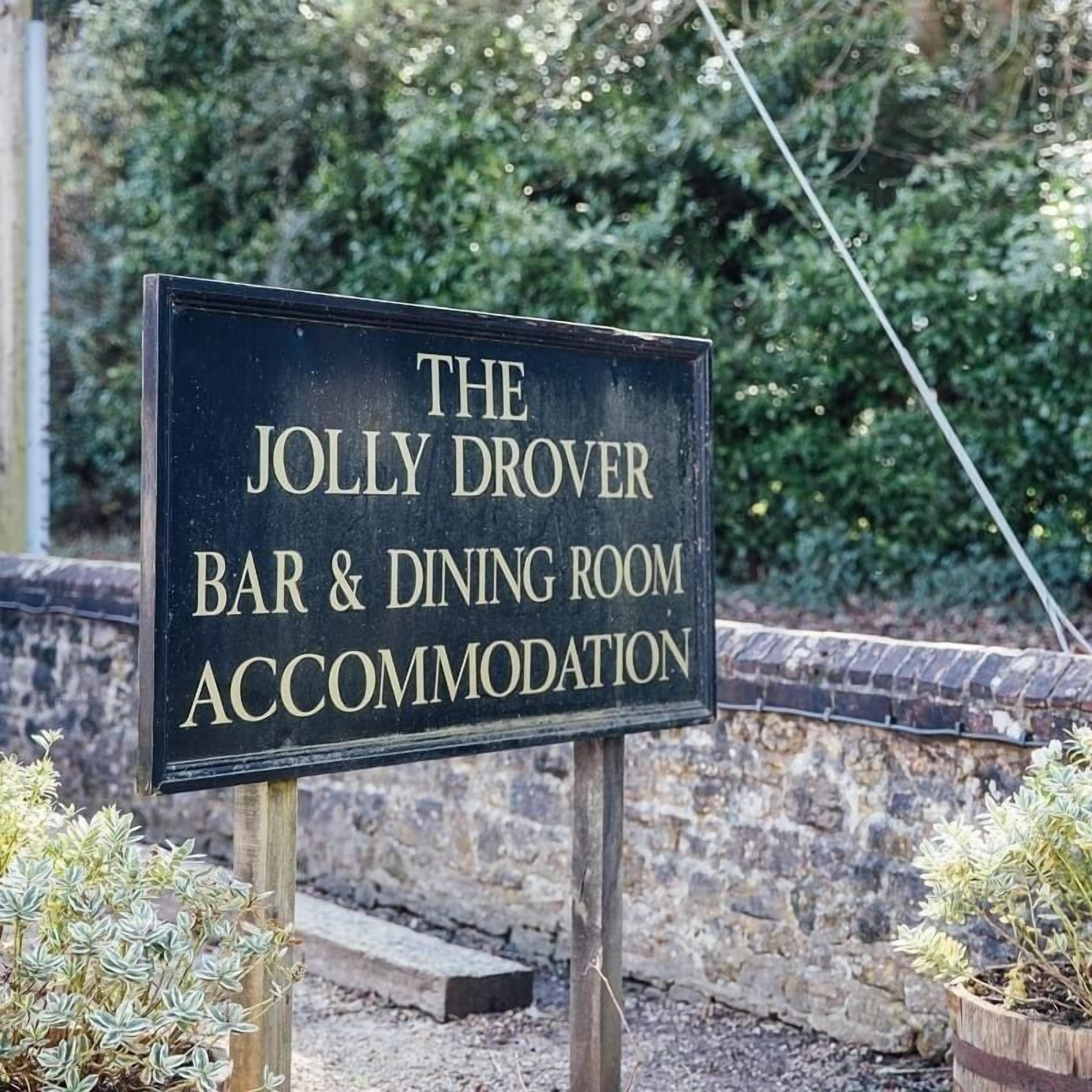 A sign for The Jolly Drover Bar & Dining Room Accommodation.