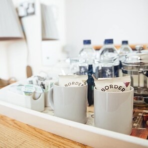 A kitchen counter with coffee makers and containers labeled 'BORDER'. - The Jolly Drover (Liss)
