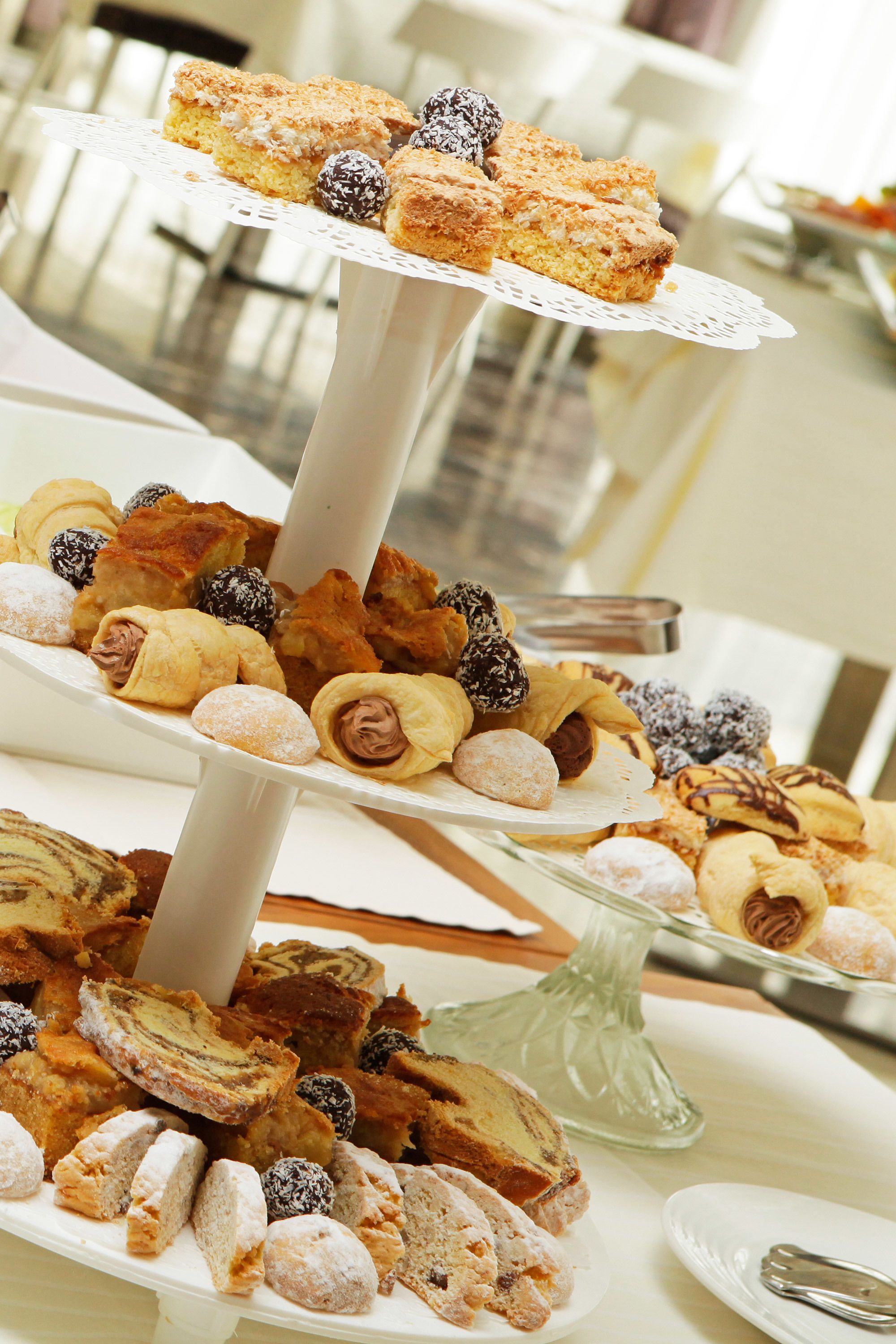 A tiered dessert stand with various pastries and sweets.
