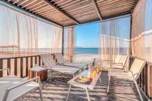 On the beach, beach cabanas, sun-loungers, beach umbrellas