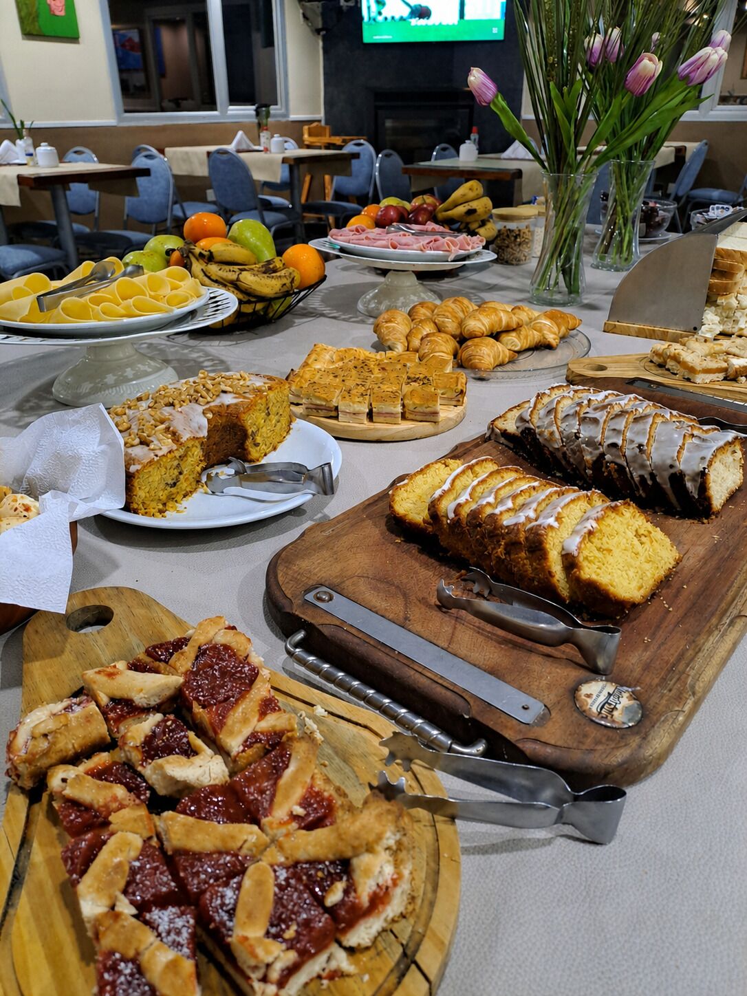 A buffet table with various food items and a bottle opener.