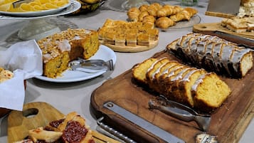 A buffet table with various food items and a bottle opener.