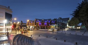 A hotel with a modern facade, multiple stories, and a prominent entrance.