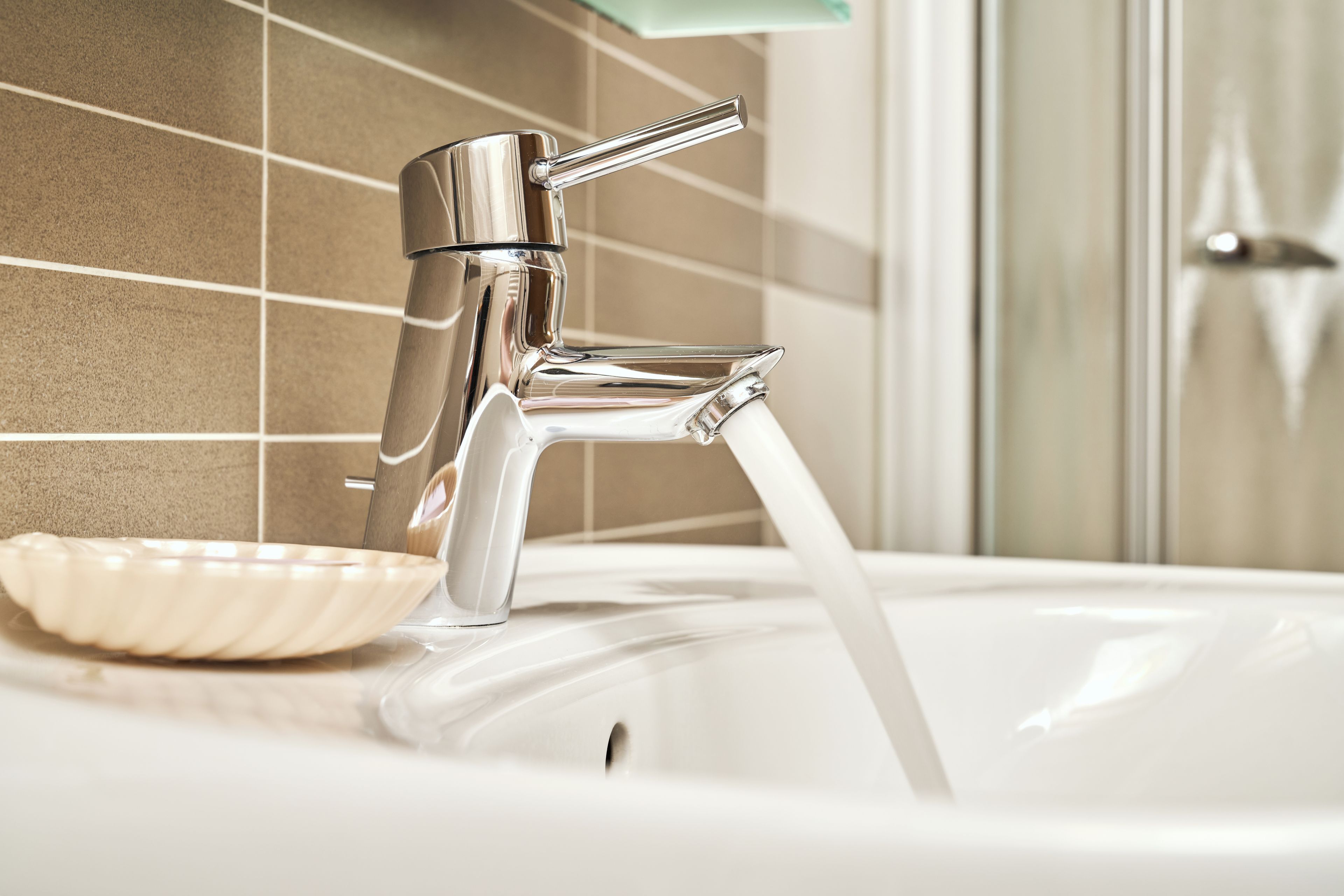 A bathroom sink with a chrome faucet and a bowl.