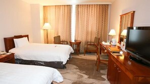 A hotel room with two beds, a desk with a TV, a chair, lamps, and a view of the outdoors through curtains. - High1 Palace Hotel & CC (Jeongseon)