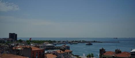 A coastal cityscape with buildings, a marina, and boats.
