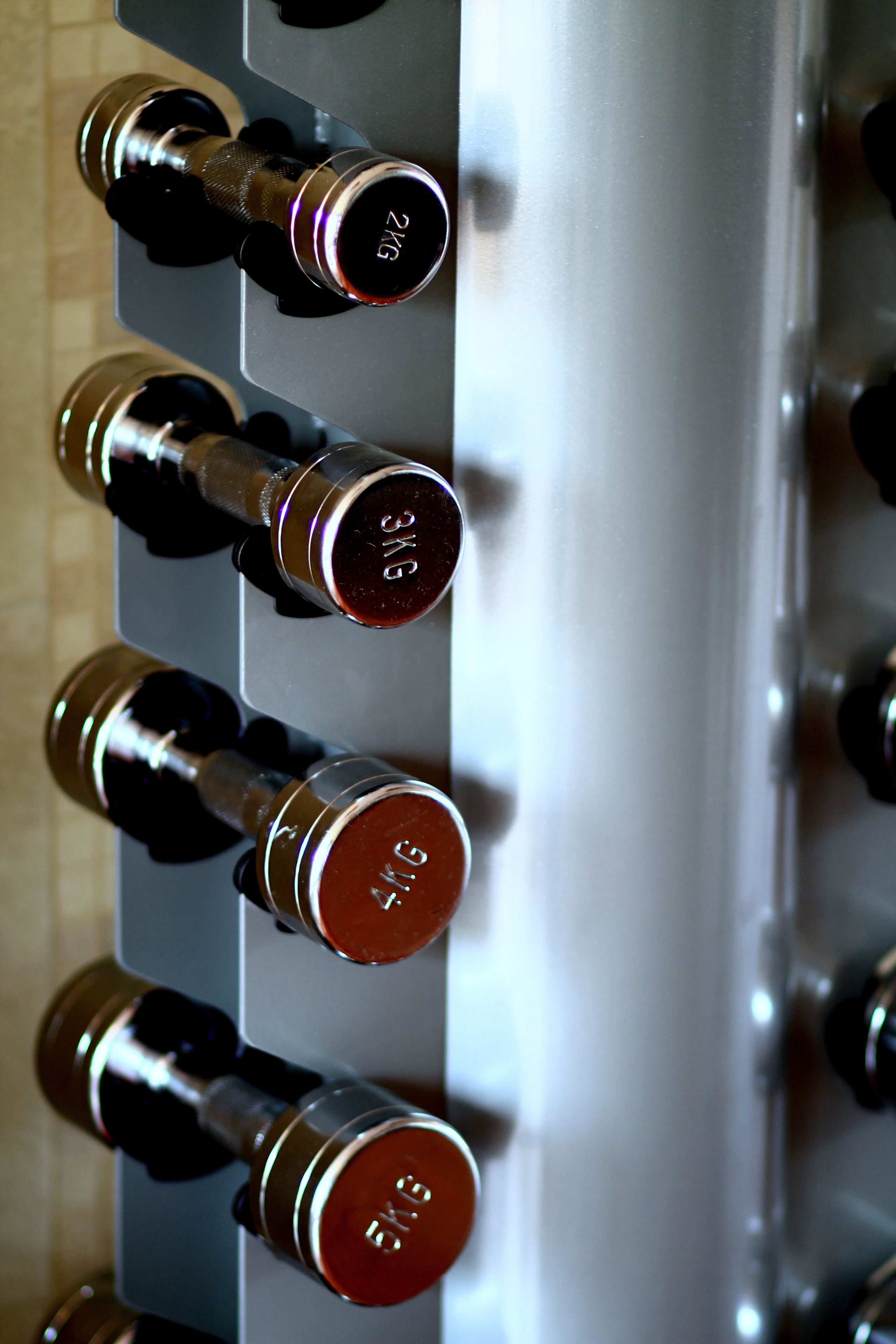 A wine rack with bottles labeled with their weight in kilograms.