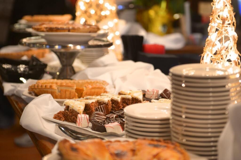 A buffet table with various desserts and pastries.