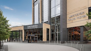 The exterior of the Leonardo Royal Hotel with a modern design, large glass windows, and a prominent entrance.