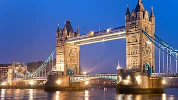 A large, historic bridge with two towers and a suspension cable.
