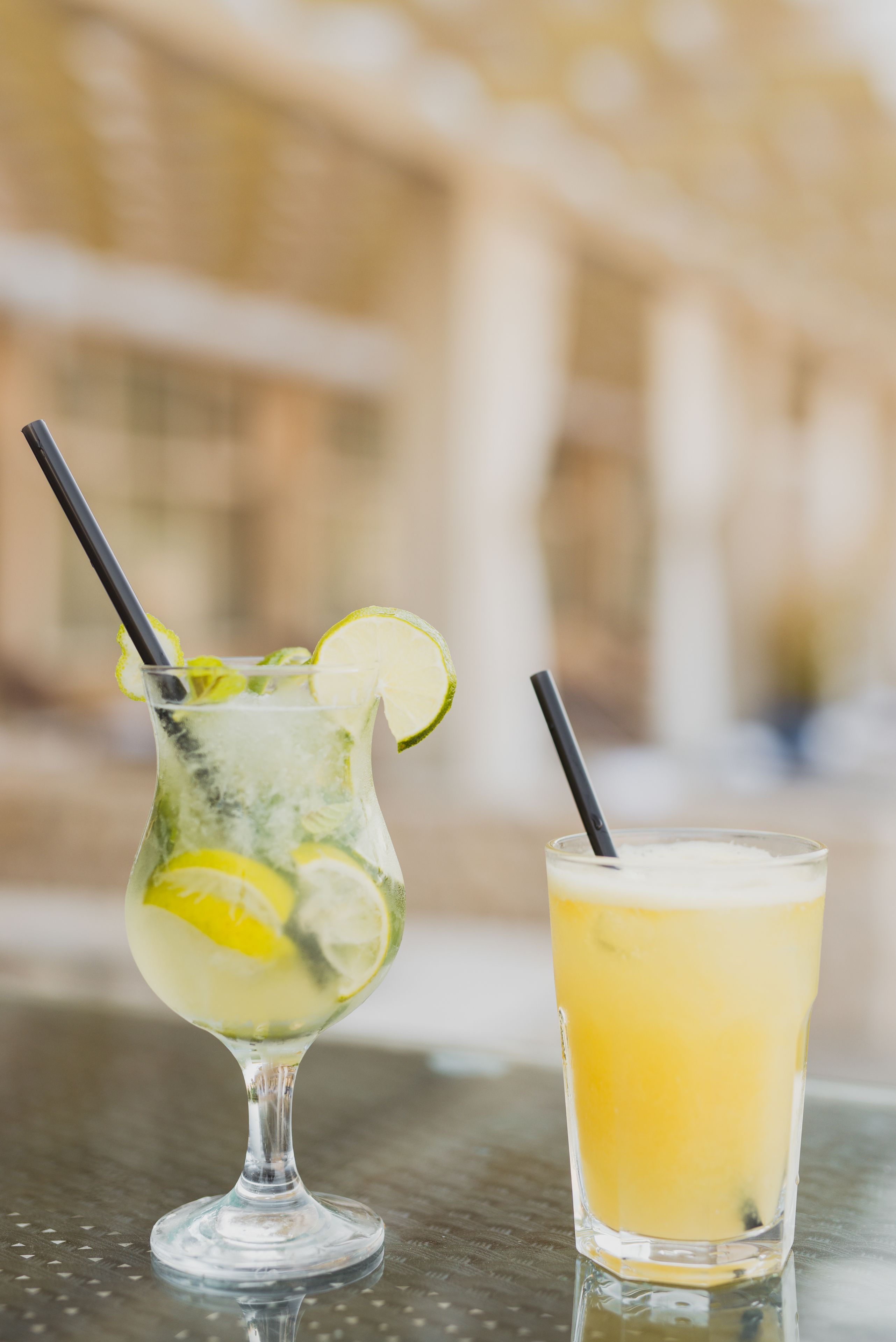 Two drinks on a table with a blurred background.