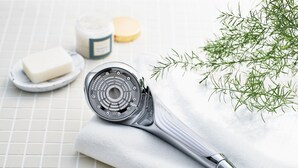 A showerhead, a bar of soap, and a bottle of liquid soap on a tiled surface. - Tokyu Stay Gotanda (Tokyo)