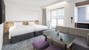 A hotel room with two beds, a sofa, a table, and a TV. - Tokyu Stay Shibuya Shin-minamiguchi (Tokyo)