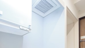 A compact kitchen with a sink, oven, and built-in microwave. - Tokyu Stay Yoga (Tokyo)