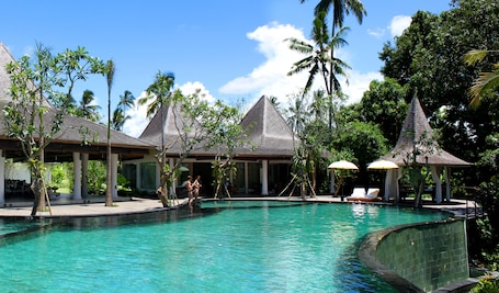 Outdoor pool, pool umbrellas, sun loungers. Ayurvedagram Bali - The Heart of Wellness & Healing