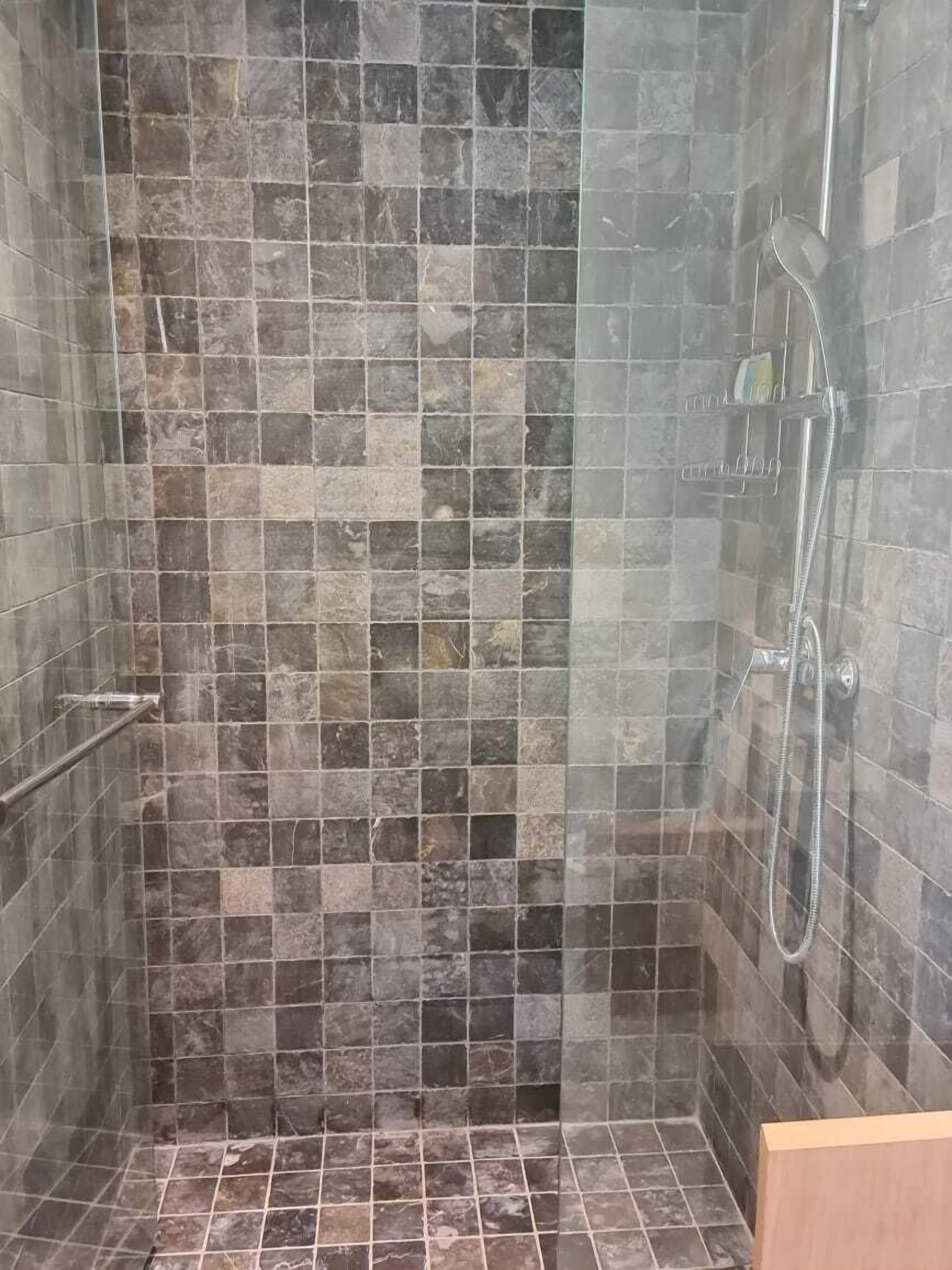 separate bathtub and shower, rainfall showerhead, designer toiletries