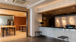 A modern hotel lobby with a reception desk, seating area, and a coffee machine. - Tokyu Stay Monzen Nakacho Tokyo (Tokyo)