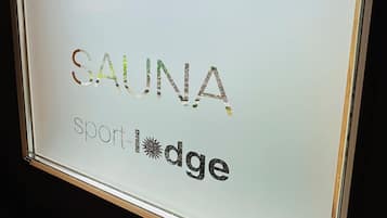 A sign with the text "SAUNA Sport Lodge".