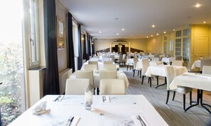 Enjoy meals in this elegant dining area with tables set for a comfortable dining experience.