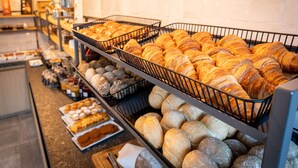 A bakery display with various baked goods including croissants, bread, and pastries. - Auberge St. Pol (Knokke-Heist)