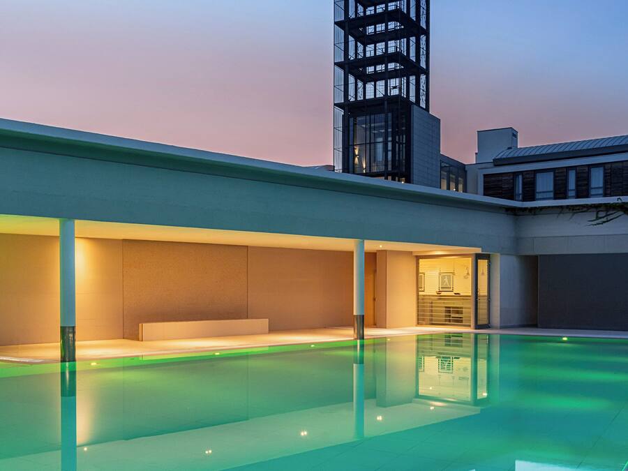 A modern building with a pool and a tower with 'MOVE' sign.