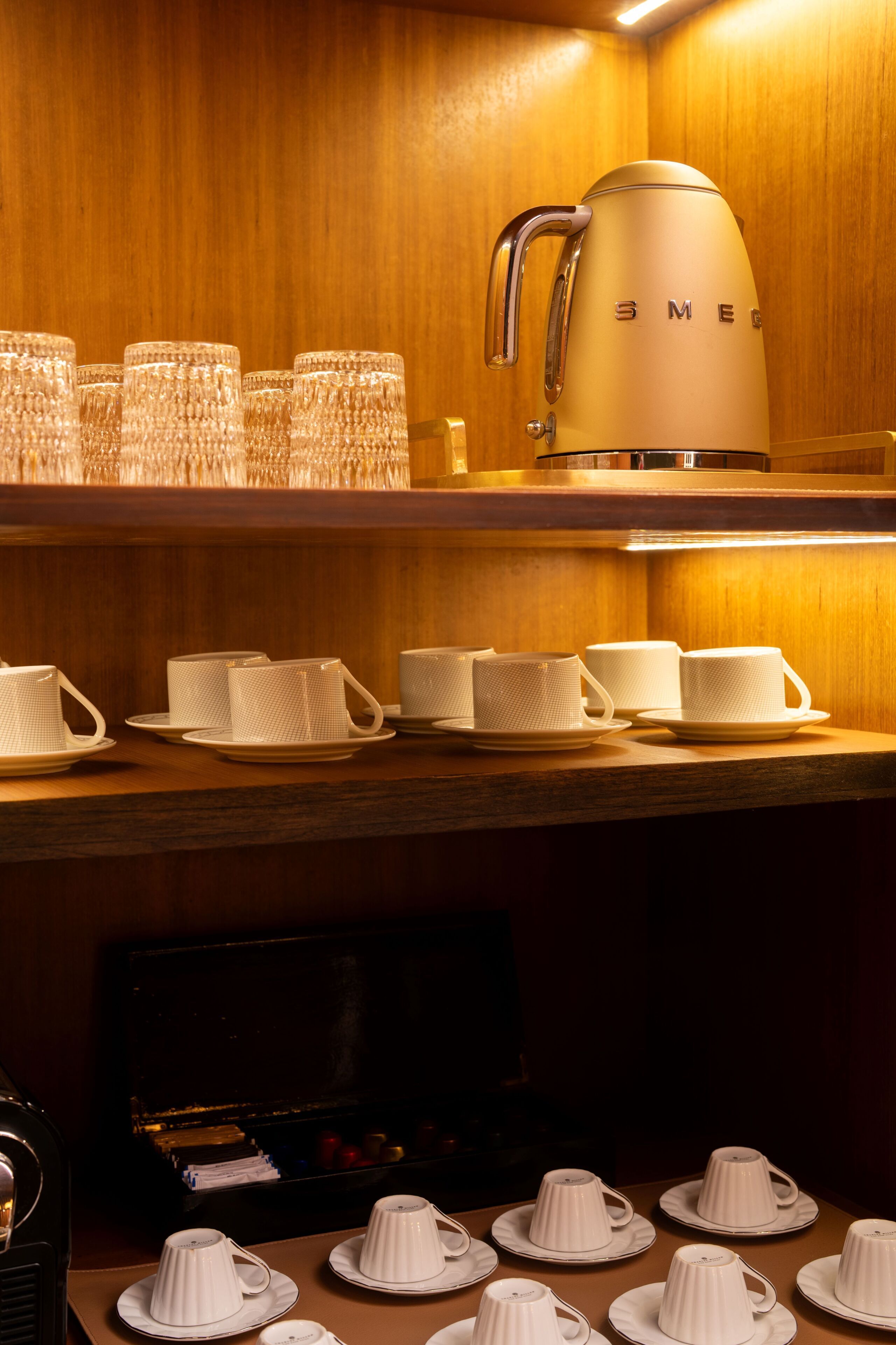 A coffee station with multiple cups and a coffee pot.