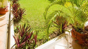 A courtyard with a tiled floor, surrounded by white walls with blue trim and multiple balconies. - Azul Sirena (Santa María Huatulco)