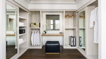 A modern bathroom with a large mirror, a sink, and a towel rack.