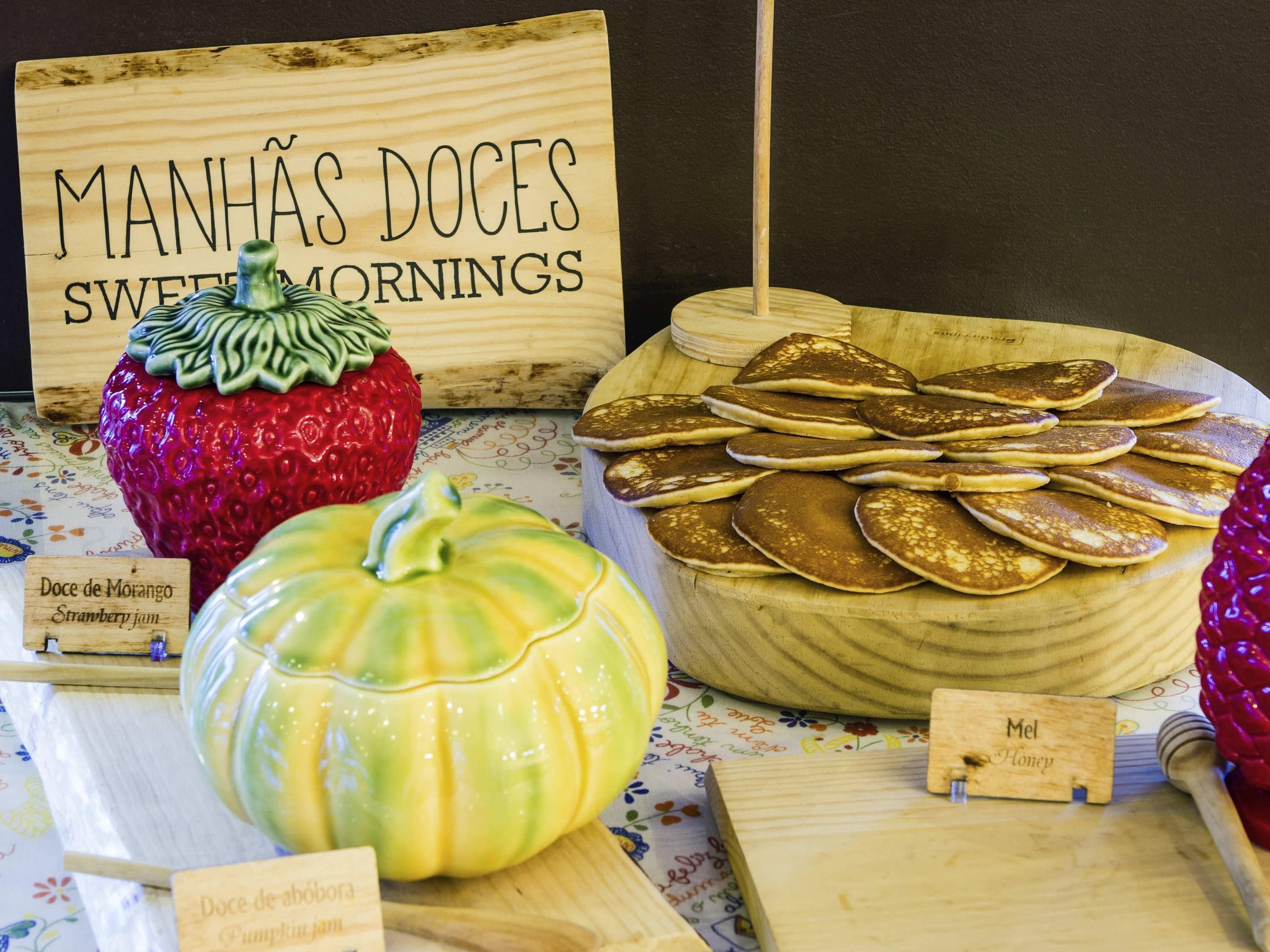 A breakfast display with various jams and honey.