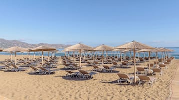 On the beach, sun loungers, beach umbrellas, beach towels