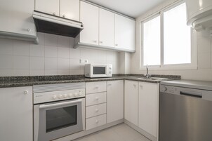 Apartment, 2 Bedrooms, Sea View | Private kitchen | Fridge, microwave, stovetop, dishwasher