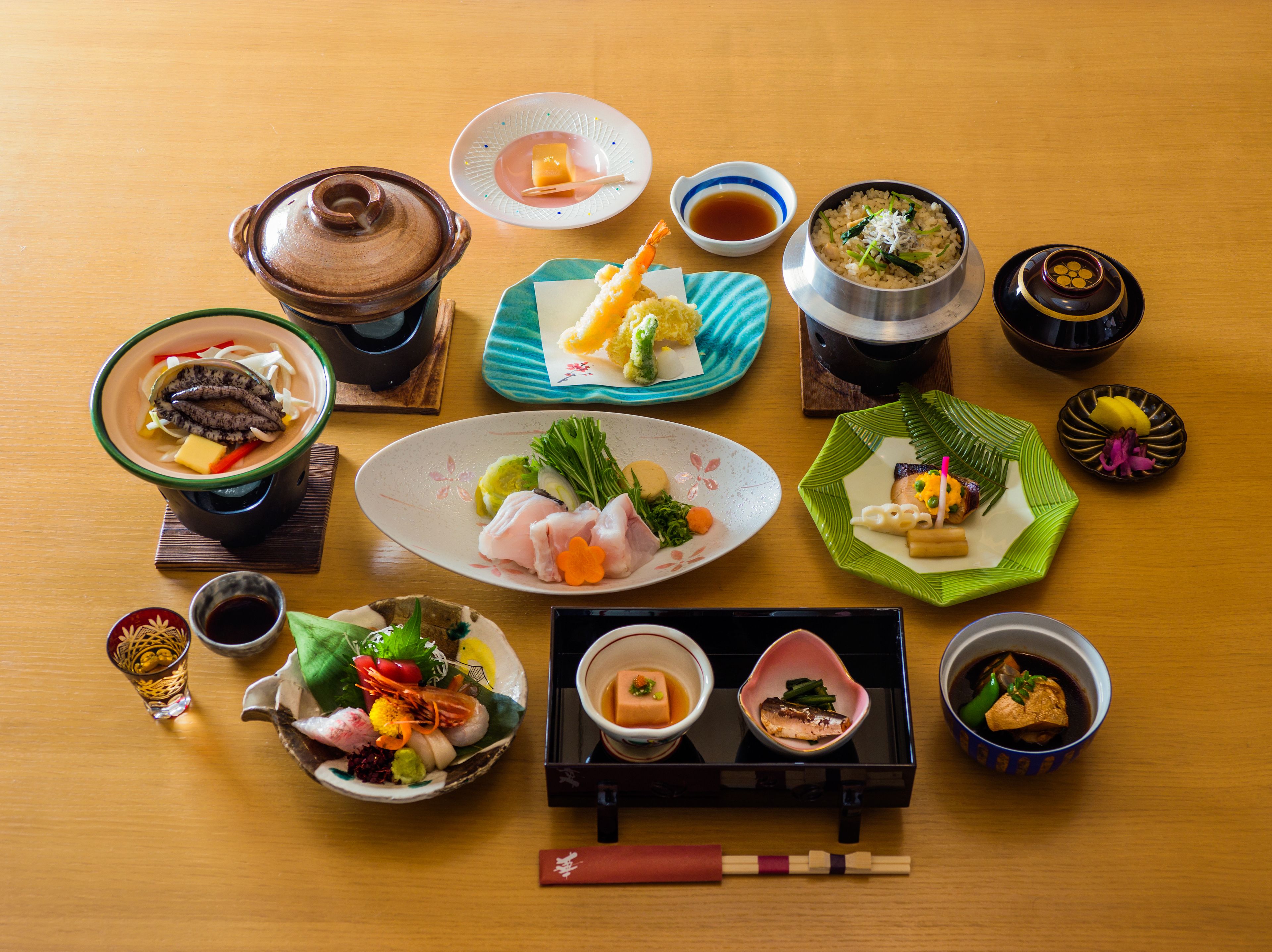 A variety of Japanese dishes arranged on a wooden table.