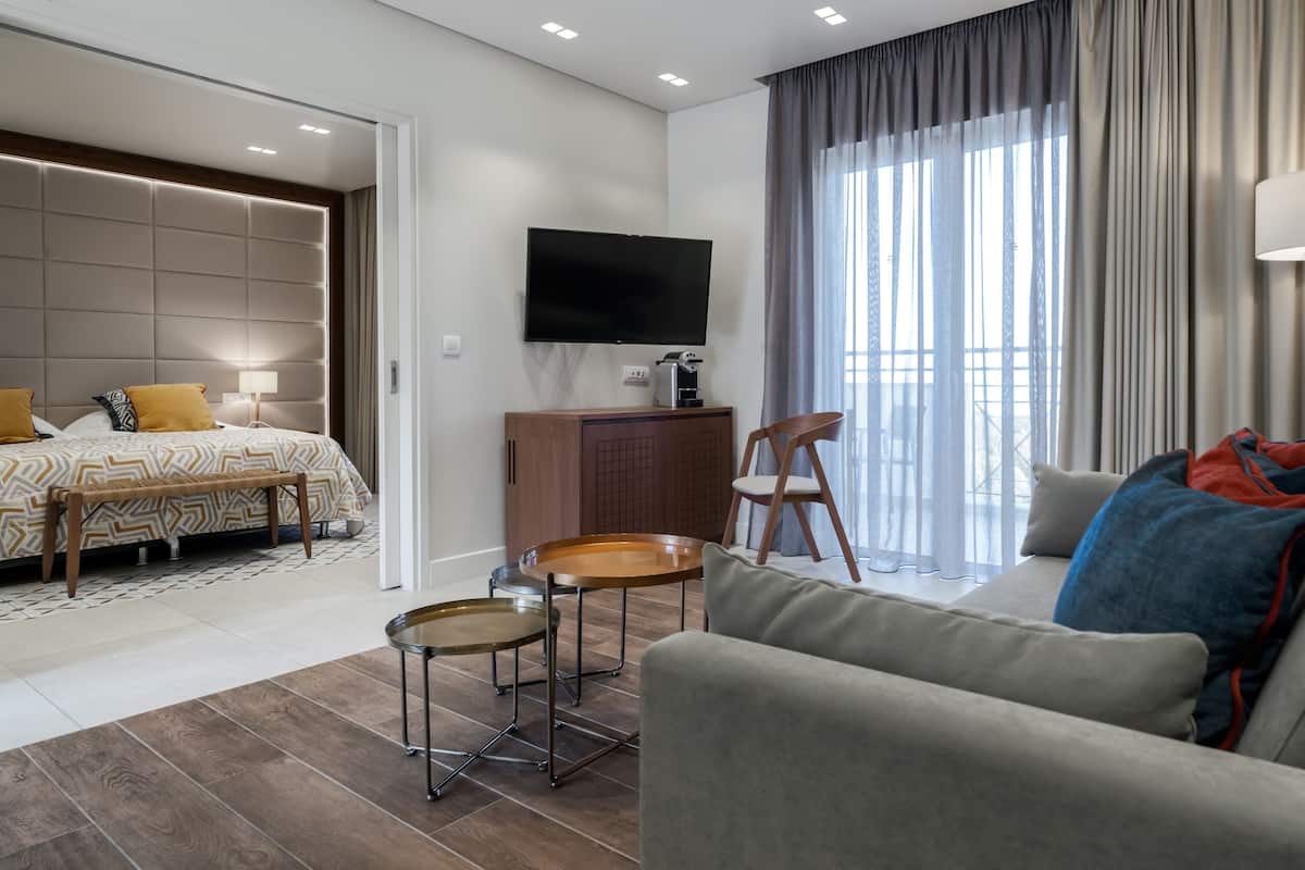 Luxury Suite, 2 Bedrooms | Living area | TV, table tennis, books
