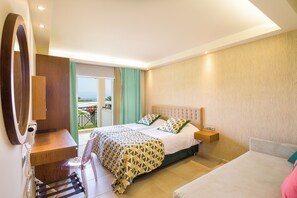 A hotel room with a bed, a desk, a chair, and a balcony with a view.