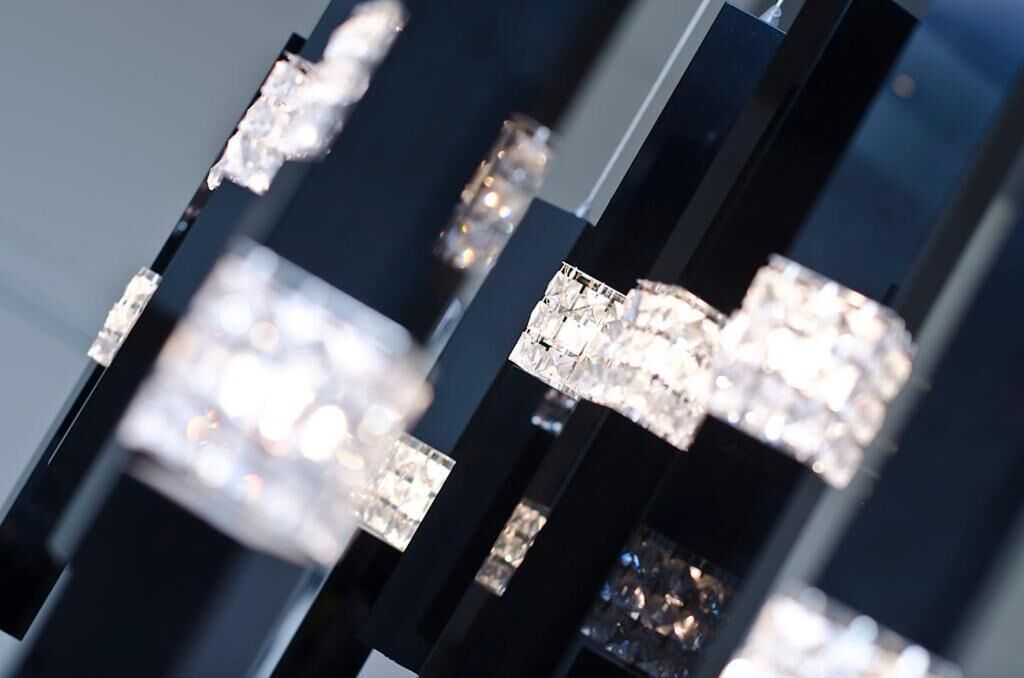 A close-up of a chandelier with multiple crystal elements.