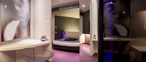 A modern bedroom with a bed, bedside table, and a chair.
