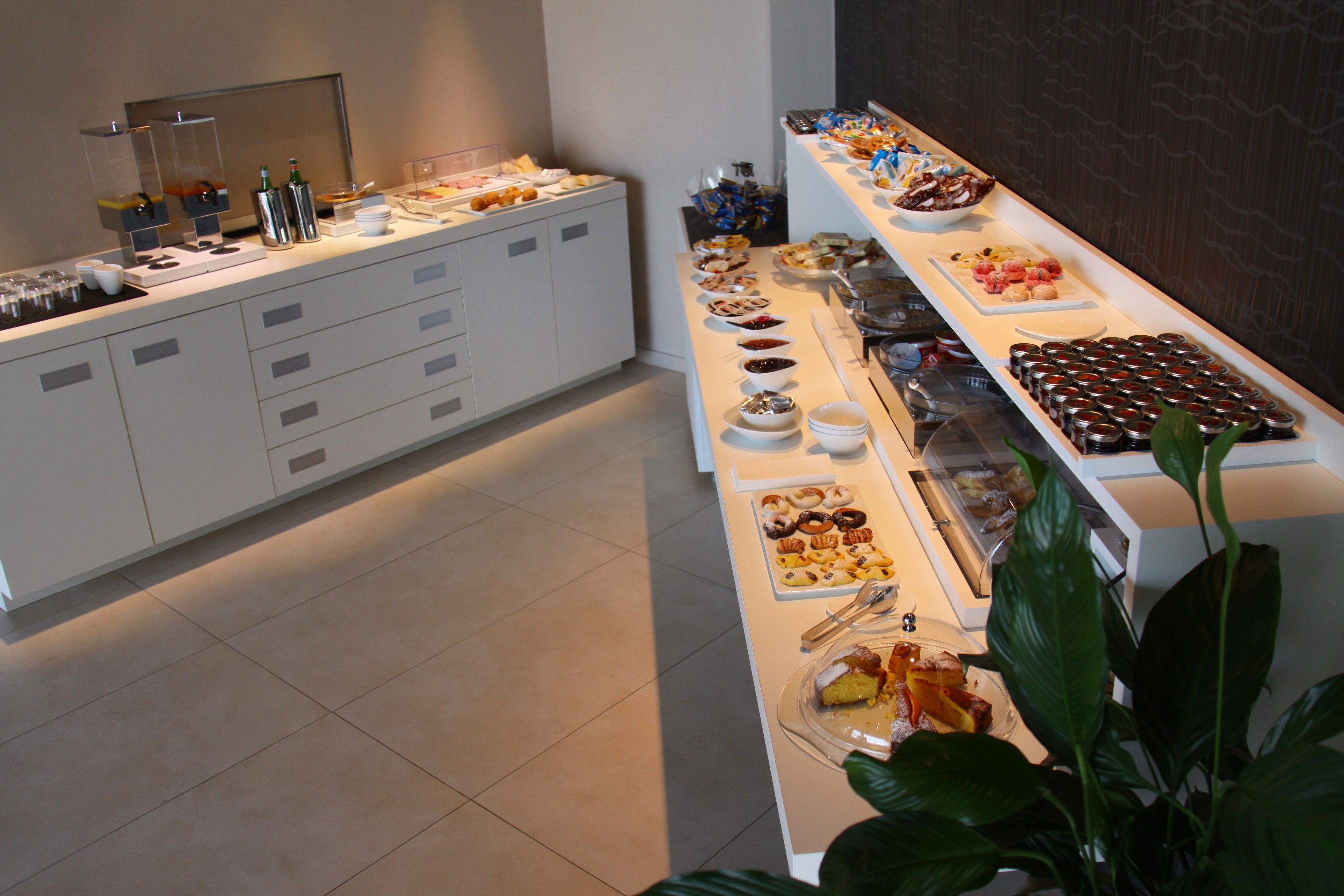 A buffet with various food items and condiments.