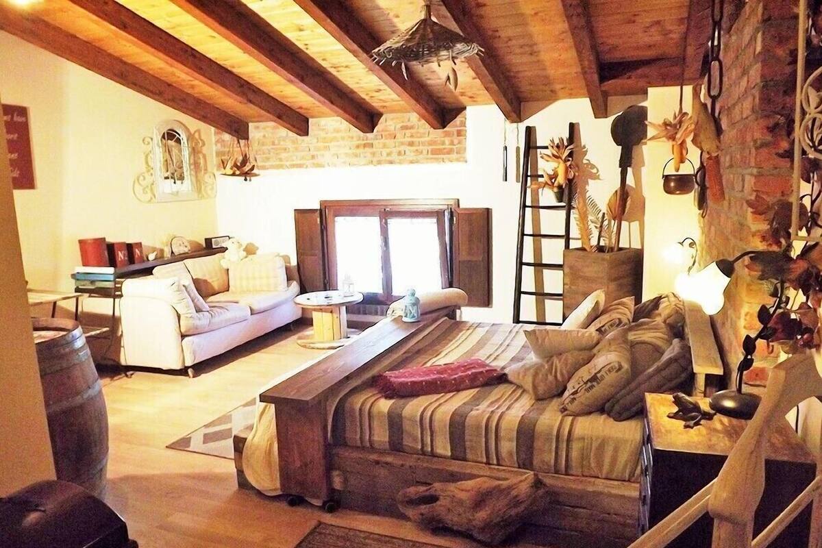 A cozy living room with a sofa, a wooden coffee table, and a fireplace.