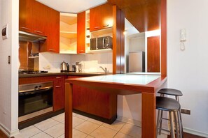 Full-size fridge, microwave, coffee/tea maker, cookware/dishes/utensils